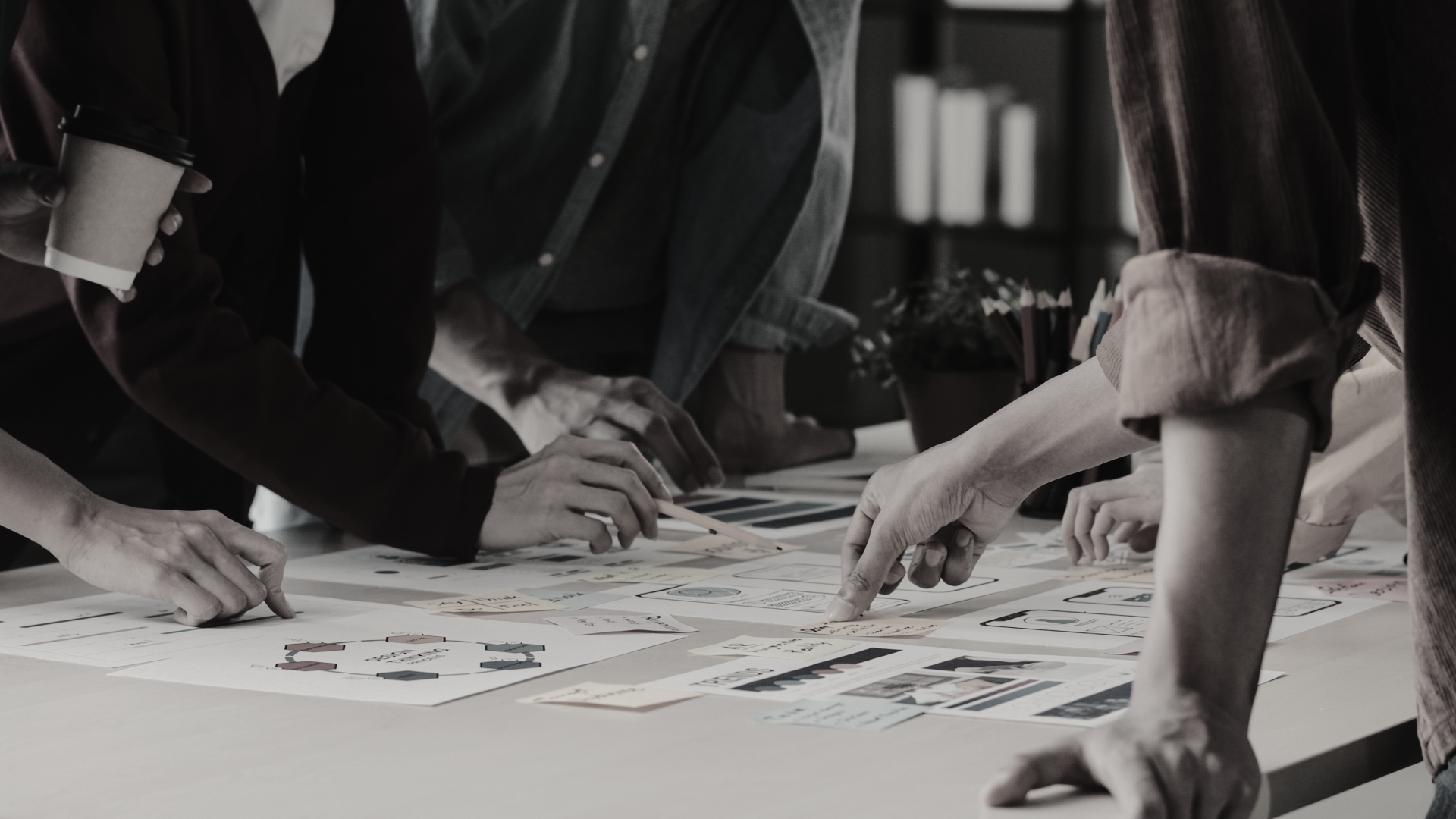 Else's team members gathering around the conference table and conducting a meeting.